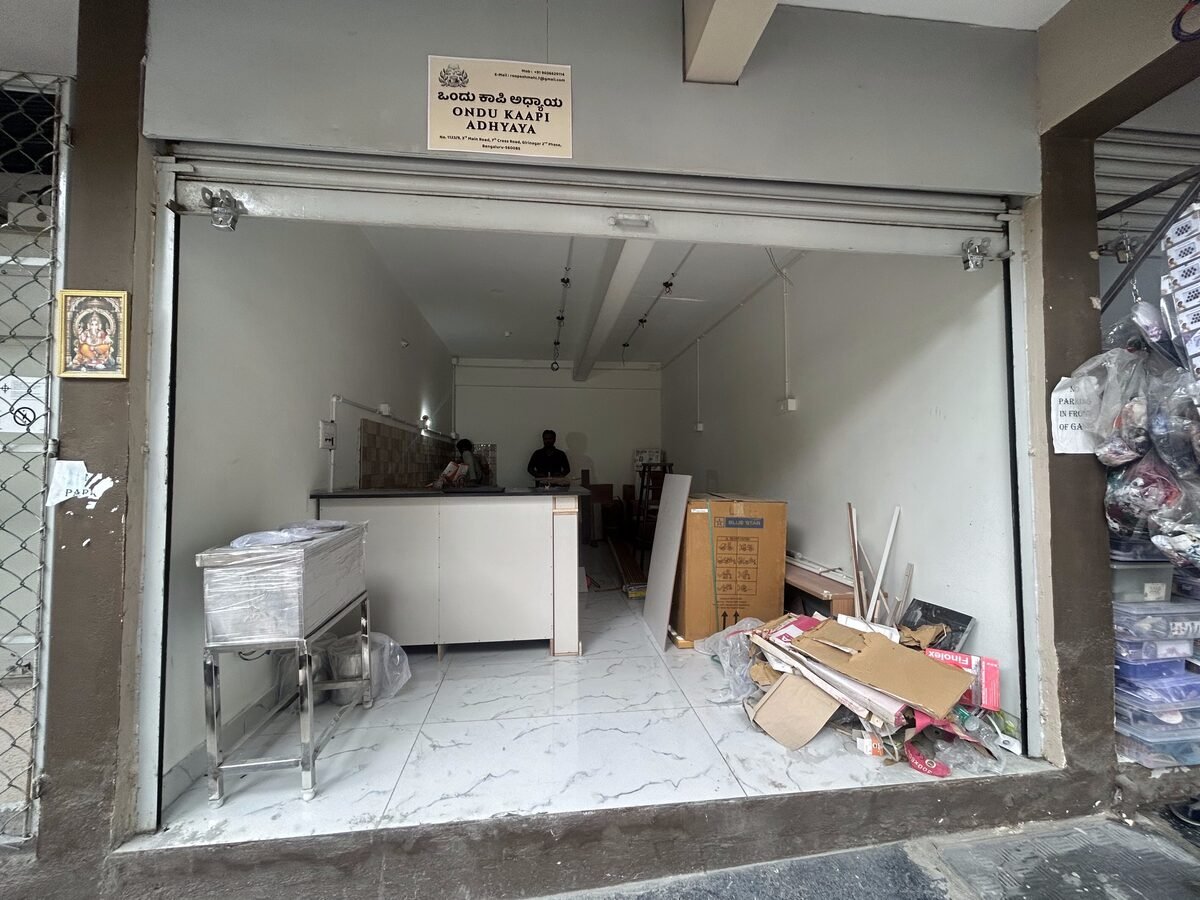 Before: Ondu Kaapi Adhyaya original plain name board above the entrance, cafe under construction